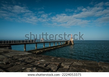 The lighthouse at Amble South Pier, Amble, Northumberland Royalty-Free Stock Photo #2224053375