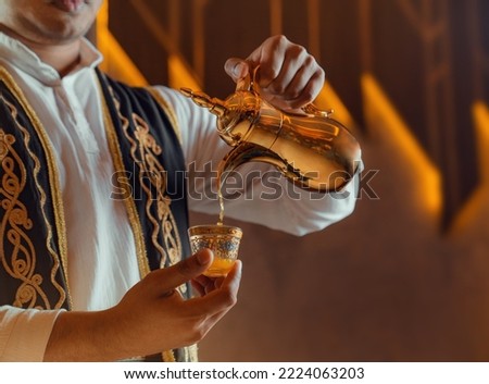 photo of traditional arabic coffee in dallah, Arabic Traditional Hospitality (Saudi Arabia). Arabic Man Hospitality  Royalty-Free Stock Photo #2224063203