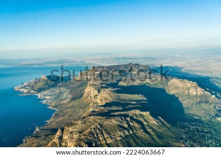 aerial landscape view with the famous Table Mountain National Park, the Lion's Head, the twelve apostle and Camps Bay with white sand beach and blue ocean - aerial panoramic view 