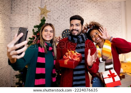 Group young friends taking selfie with excited and enjoy with smart phone together at home, man and woman taking a photo in celebration xmas eve with cheerful, x-mas and new year or holiday concept.