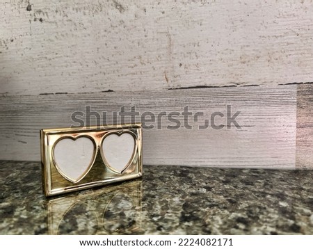 Tiny gold colored heart shaped picture frame