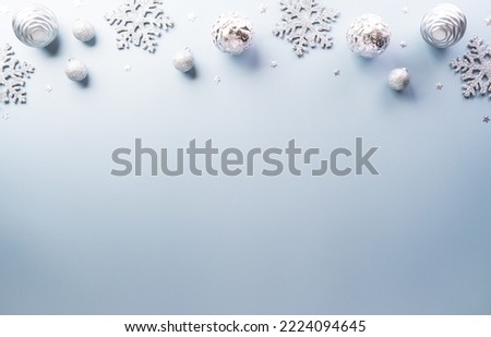Christmas and new year background concept. Top view of Christmas star and snowflake on pastel blue background.