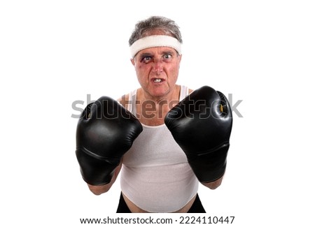 Grimacing older man fighter with a black eye and boxing gloves 