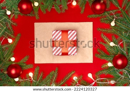 box with a Christmas gift on a red festive background.