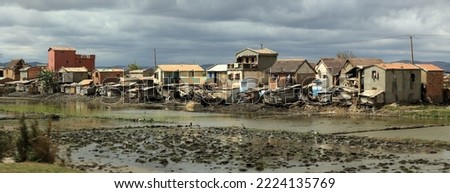 Housing around the city. The slum village in Madagascar. Unfavorable people Royalty-Free Stock Photo #2224135769