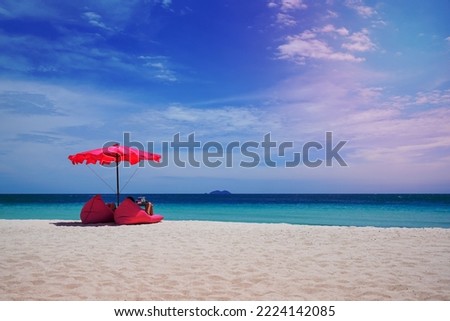 Pink parasol and  seat on the tropical beach, Vacation background.,Idyllic beach 