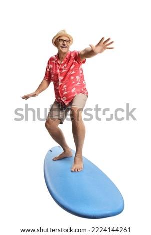 Happy mature male tourist on top of a surfing board isolated on white background