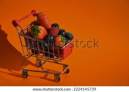 fresh, ripe berries, raspberries, strawberries and blueberries in the shopping cart. proper nutrition. vitamin food. background for the design.