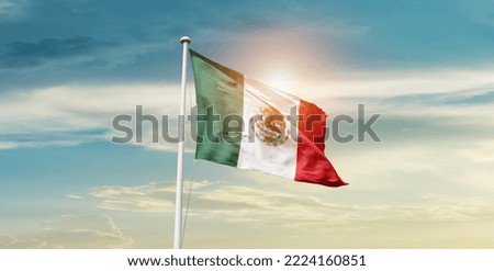 Mexico national flag waving in beautiful clouds.