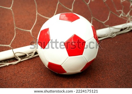 Football ball and football goal on playground rubber coating