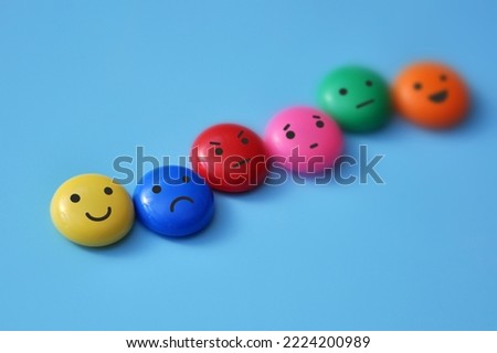 A variety of human emotions: joy, serenity, anger, sadness on colored balls