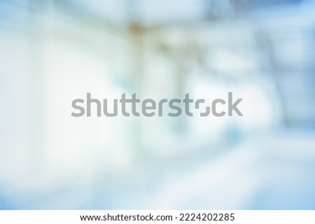 BLURRED OFFICE BACKGROUND, LIGHT SPACIOUS BUSINESS HALL WITH WINDOW LIGHT REFLECTIONS, EMPTY DEFOCUSED INTERIOR