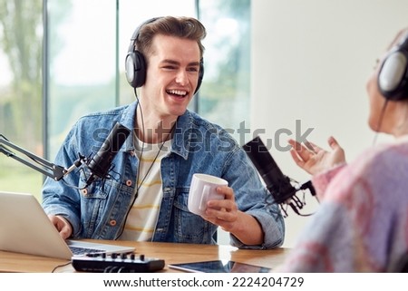 Couple Recording Podcast Or Broadcasting Interview On Radio In Studio At Home With Laptop