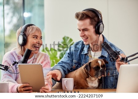 Couple With Dog Recording Podcast Or Broadcasting Interview On Radio In Studio At Home With Laptop