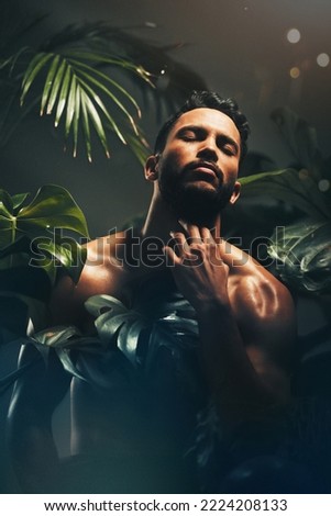 Beauty, skincare and nature with a man model in studio on a natural rainforest or amazon background. Cosmetics, wellness and plants with a handsome young male posing indoors on a jungle setting Royalty-Free Stock Photo #2224208133