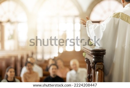 Congregation, religion and faith with priest, in church and preaching sermon, speaking and spiritual. Leadership, talking and connect with people, believers and in chapel for forgiveness or guidance. Royalty-Free Stock Photo #2224208447