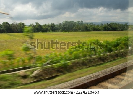 Beautiful blurred landscape of railroad and nature scenery captured from a train window.