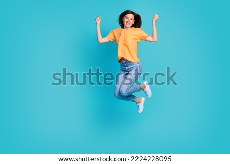 Full length photo of cheerful overjoyed lady football fan support favorite team yes hooray empty space isolated on blue color background