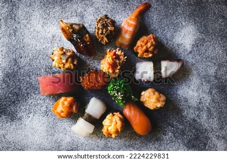 Assorted rolls and sashimi on a gray textured background. Asian food. food photography