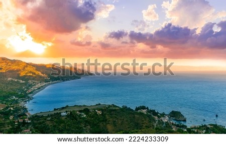 travel landscape scenic picture of beautiful highland green mountain town in sunrise or sunset with sea shore on background with trees in garden and amazing colorful sky