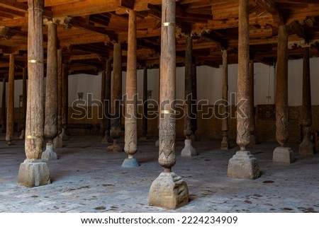 Ancient carved wooden columns in the medieval Juma mosque. Khiva, Uzbekistan Royalty-Free Stock Photo #2224234909