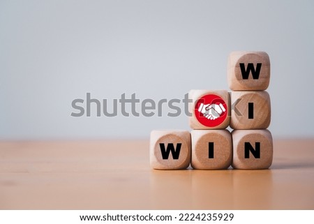 Win and win wording with hand shaking icon on wooden cube block for success and business deal situation concept. Royalty-Free Stock Photo #2224235929