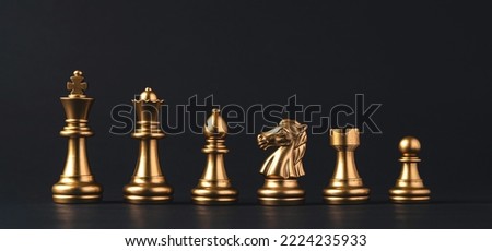Golden chess include king queen horse ship and pawn on dark background. Royalty-Free Stock Photo #2224235933