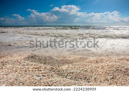 storm waves and a pebble sea beach as a place of dramatic events