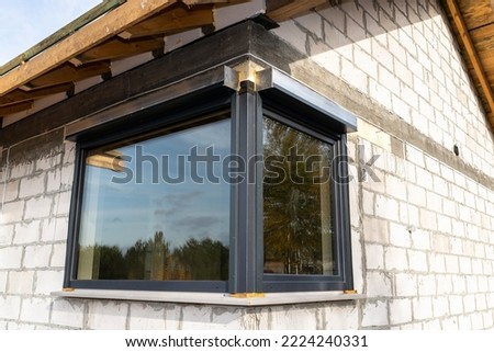 Warm installation of a three-layer window with a polystyrene window sill, view from the outside. Royalty-Free Stock Photo #2224240331
