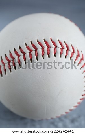 Baseball ball on grey table, closeup view