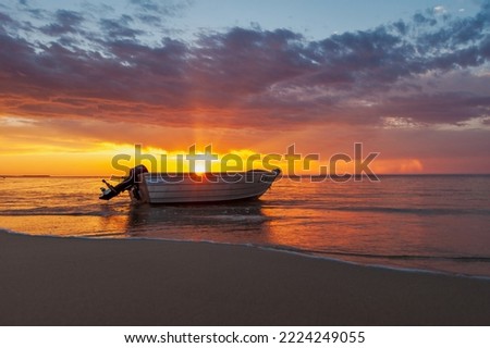 Boat on the beach at sunset. Eighty Mile Beach, Western Australia.