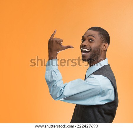 Portrait happy silly goofy man gesturing with hand thumb to go out party get drunk, hammered, wasted, isolated on orange background. Positive human emotion Facial Expression feeling sign body language