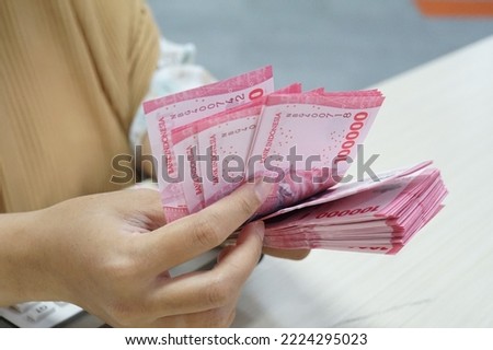 New Indonesian rupiah banknotes series with the value of one hundred thousand rupiah IDR 100.000. Indonesian rupiah for background. Royalty-Free Stock Photo #2224295023