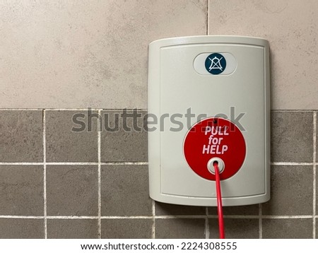 Pull for Help. A red emergency call alert button string in the hospital toilet.