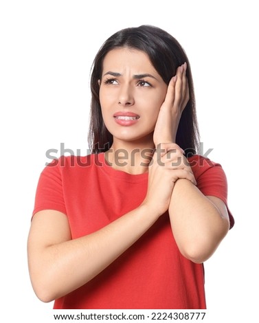 Young woman suffering from ear pain on white background Royalty-Free Stock Photo #2224308777