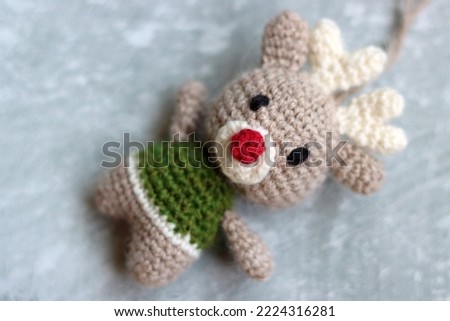 Amigurumi Reindeer close up photo. Handcrafted Christmas toy. Crochet pattern. 
