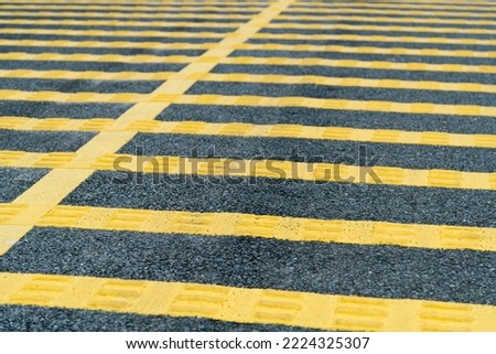 Yellow speed bump on asphalt road.