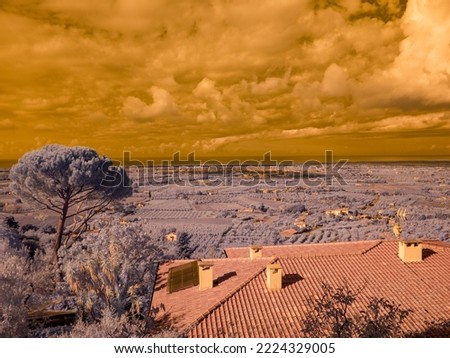 Infrared photography, panorama taken from the main square of Castagneto Carducci Tuscany Italy towards the sea and the plain below