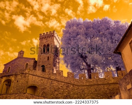 Infrared photography, view of the castle, its walls and the tower of Castagneto Carducci, Tuscany Italy