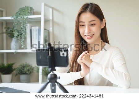 Close up on Young asian woman recording herself interview video via smartphone for her vlog.