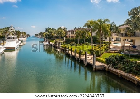 Aerial drone view of coral bay area, exclusive and luxurious neighborhood in miami, lush tropical vegetation, luxury homes and yachts, blue sky, Royalty-Free Stock Photo #2224343757