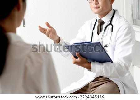 Back view of male doctor and female patient examining at hospital
 Royalty-Free Stock Photo #2224345119