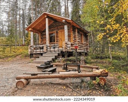 Wooden house and the place for bonfire in the forest. Golden autumn in Paanajarvi National Park, Karelia, Russia. 