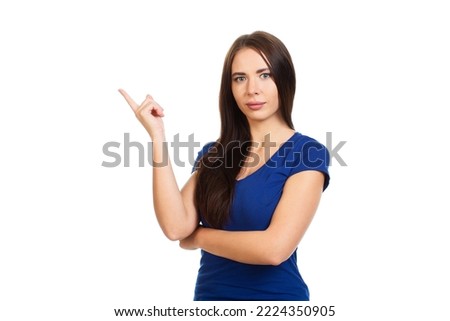 Young, beautiful smiling girl isolated on a white background points his fingers at the place for promotions, offers or advertising.