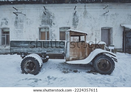 Military truck lorry from the times of the USSR against the background of an old building in winter