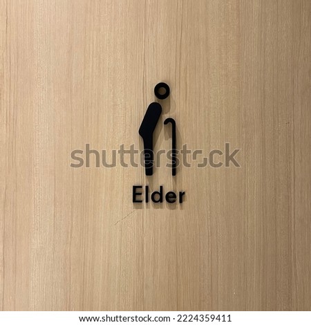 Wooden elder sign in the restroom