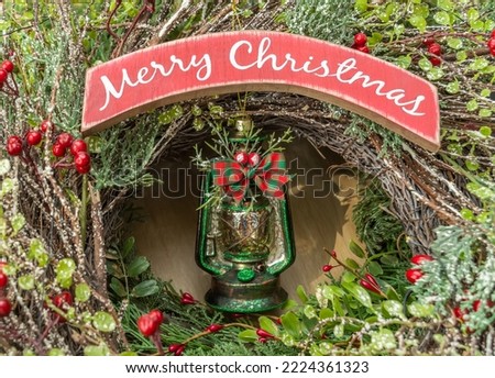 merry chtistmas written with vintage oil lamp over christmas holiday wooden planks rural background. 