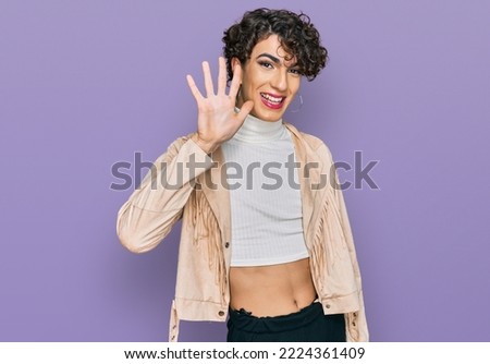 Handsome man wearing make up and woman clothes showing and pointing up with fingers number five while smiling confident and happy. 