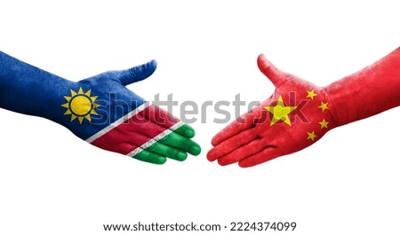 Handshake between China and Namibia flags painted on hands, isolated transparent image.