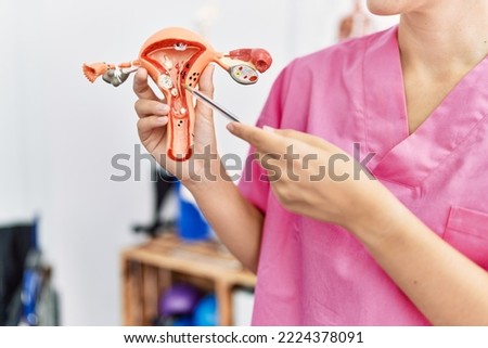Gynecologist woman holding fallopian tube anatomical model standing at the clinic. Royalty-Free Stock Photo #2224378091